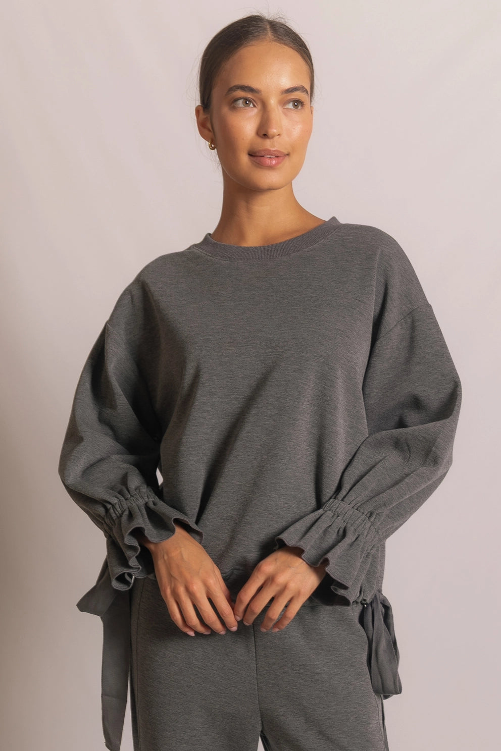 ADJUSTABLE WAIST TOP WITH RUFFLE BOW SLEEVE